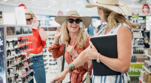 Women trying on hats